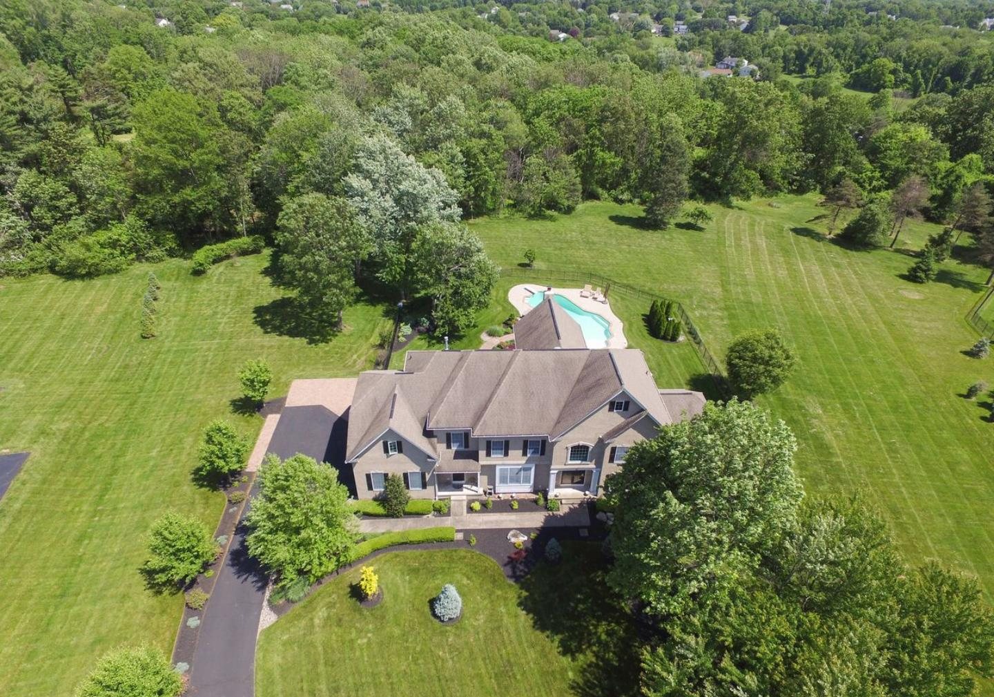 Aerial view of 13 Pickering Drive, Newtown, a home on a wooded lot